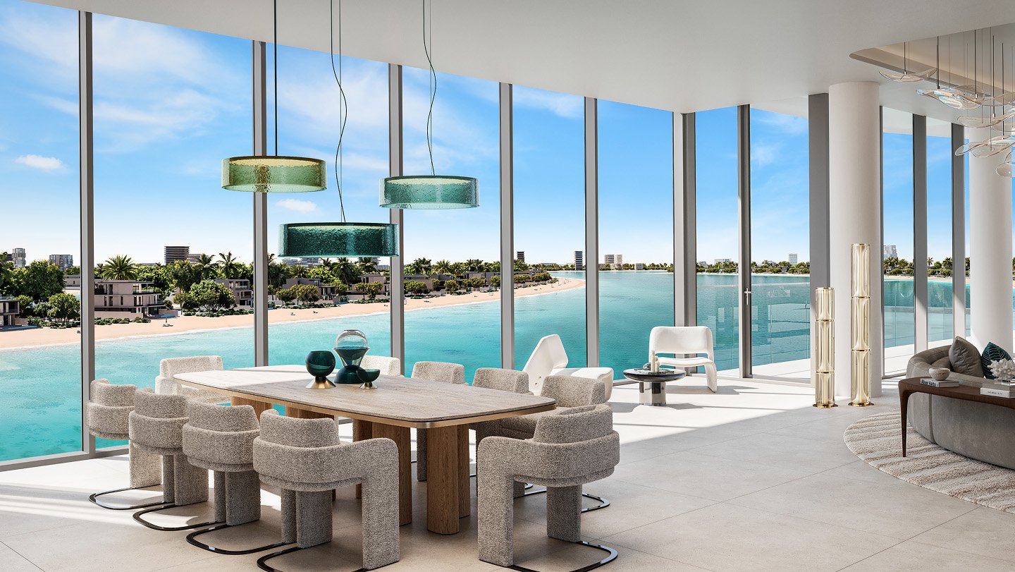 Modern waterfront dining area at Palm Central Residences, Palm Jebel Ali, with floor-to-ceiling glass windows and panoramic lagoon views.